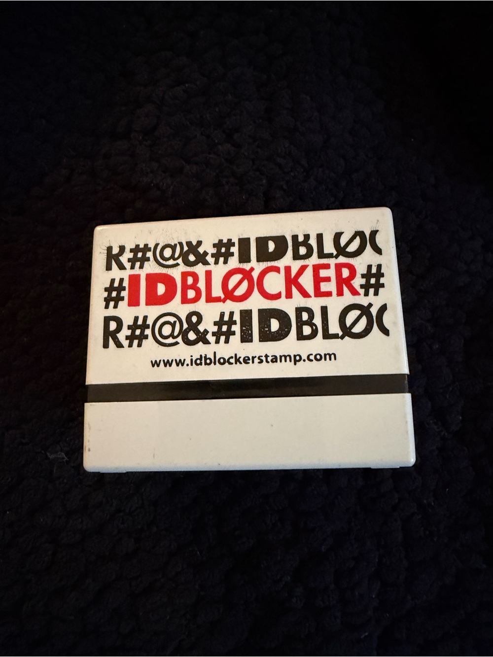 White and Black IDBLOCKER Stamp with Red Logo